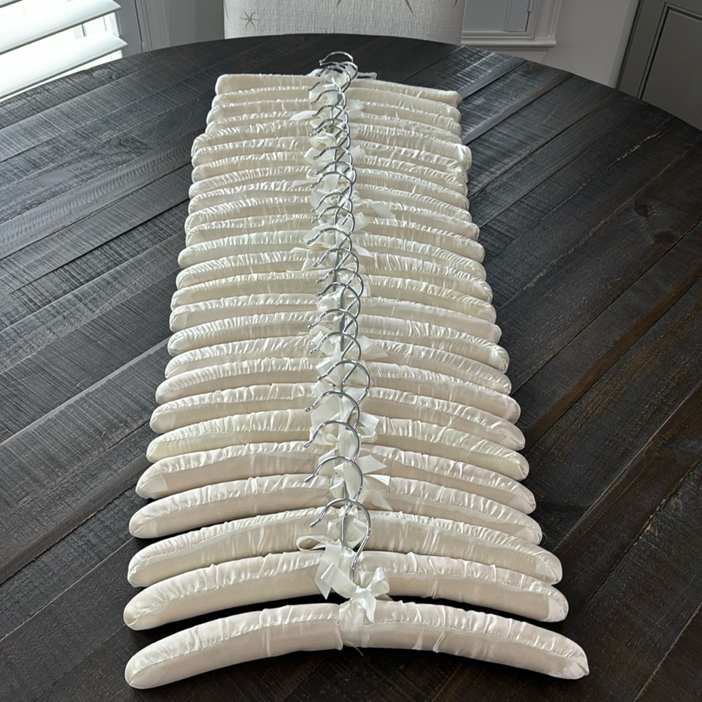 25 cream satin hangers with bows.